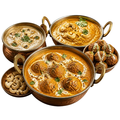 Two cashew curries, a kofta curry and a bowl of whole cashews