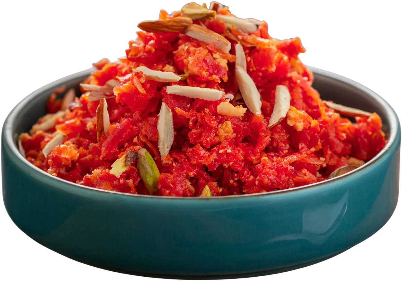 Bowl of red carrot halwa topped with slivered almonds