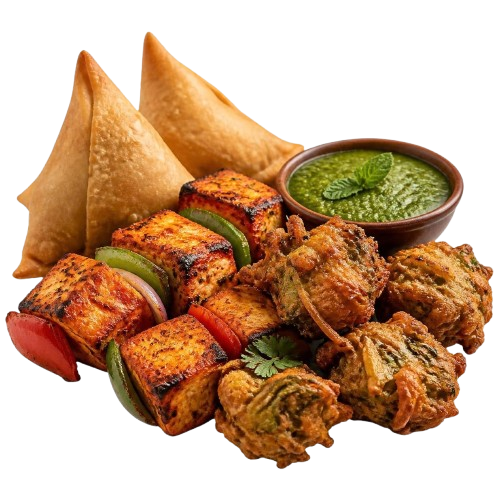 Samosas, an onion bhaji, a paneer skewer and a bowl of green chutney
